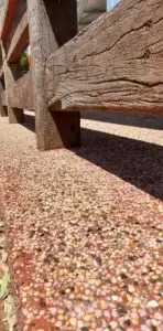 Exposed aggregate with seeded white and green stone on oaka concrete